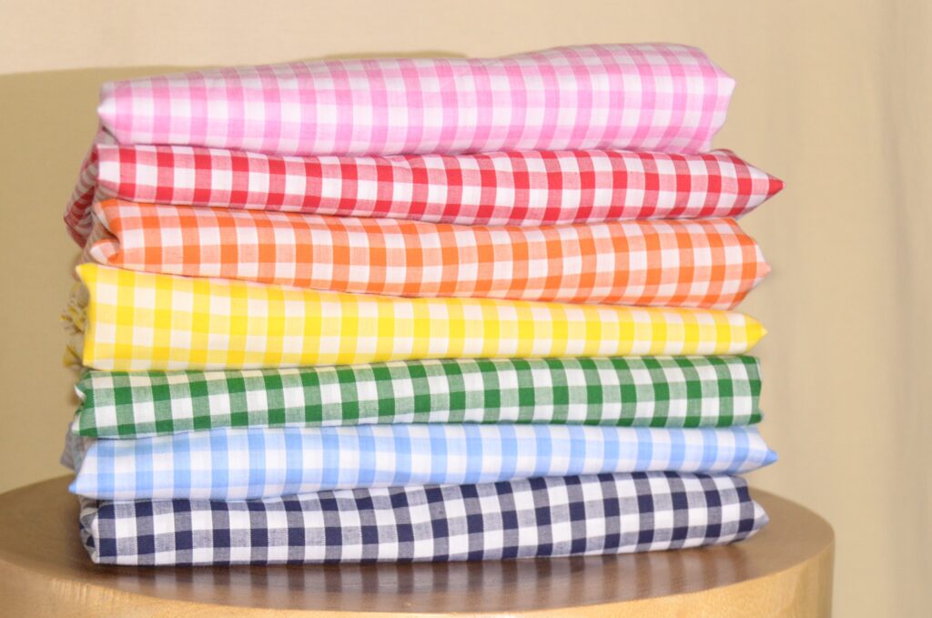 gingham skirt colorways stacked upon each other, pink, red, orange, yellow, green, sky blue, navy blue