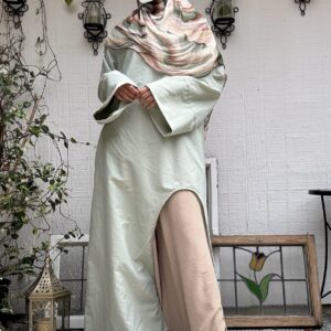 pistachio green architect abaya, oversized cuffs, arched "window" open on front right side